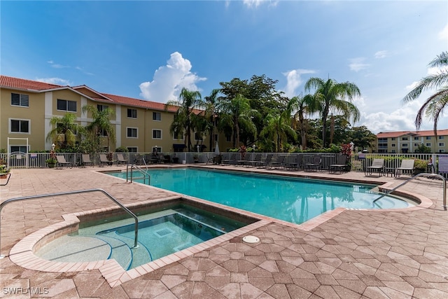 8224 Key Royal Cir Unit 232, Naples, FL 34119 - community pool featuring a hot tub and a patio