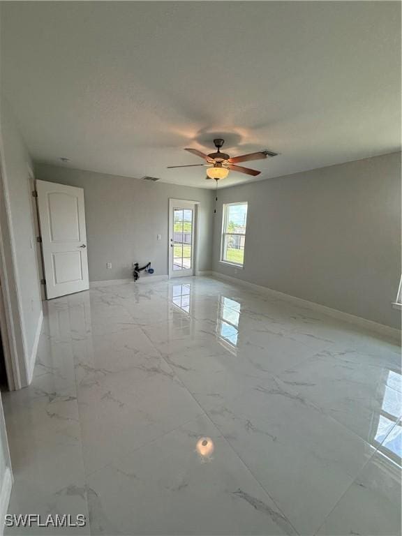 5109 Balmer St, Lehigh Acres, FL 33971 - unfurnished room featuring baseboards, light marble finish flooring, and a ceiling fan