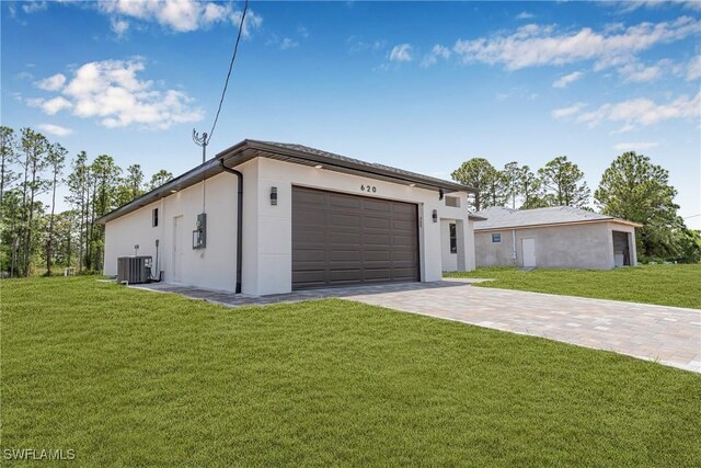 view of front of property featuring central AC, driveway, a front lawn, and a garage