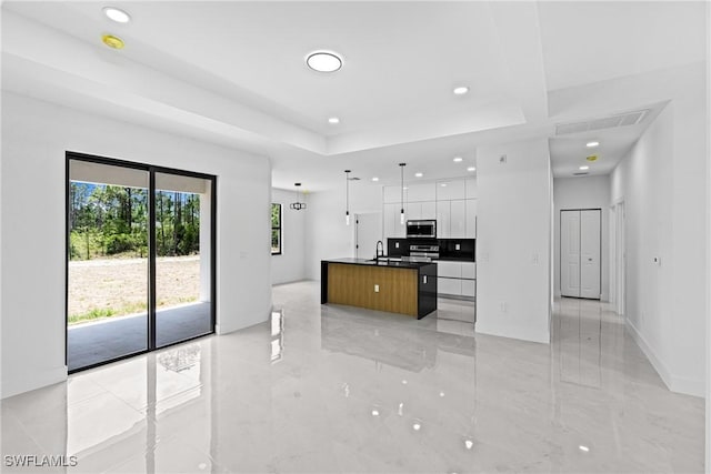 kitchen with modern cabinets, stainless steel appliances, a sink, white cabinets, and recessed lighting