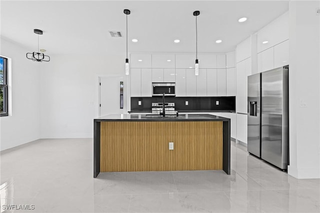 kitchen with appliances with stainless steel finishes, modern cabinets, dark countertops, white cabinets, and recessed lighting