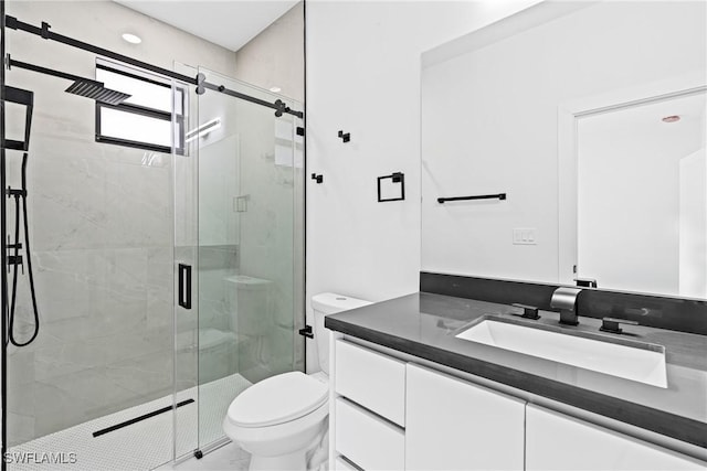 bathroom featuring vanity, toilet, and a shower stall