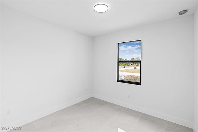 empty room with baseboards and light marble finish flooring