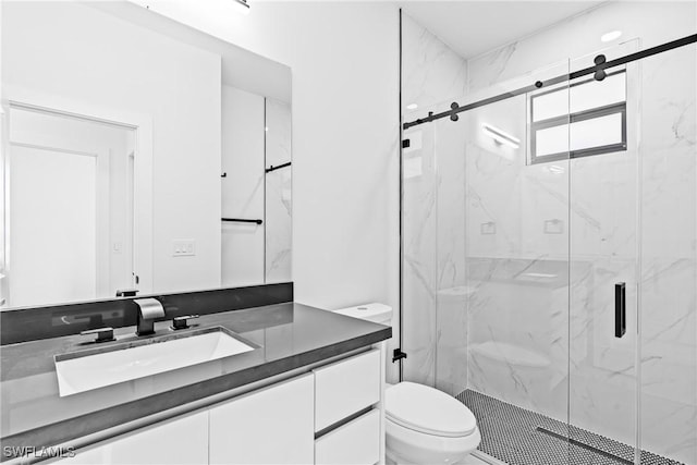 bathroom featuring toilet, vanity, and a marble finish shower