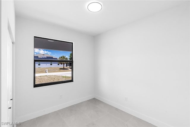 empty room featuring baseboards