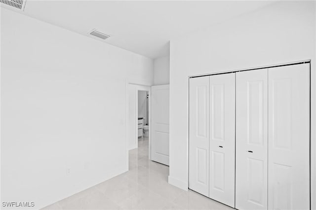 unfurnished bedroom featuring a closet and baseboards
