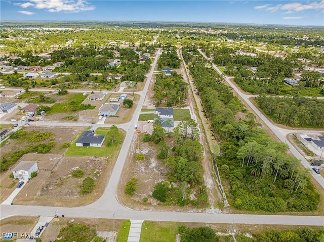 aerial view of property and surrounding area with nearby suburban area