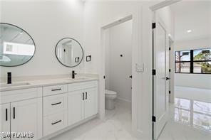 467 Paddock St, Lehigh Acres, FL 33974 - bathroom featuring double vanity and toilet