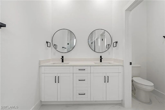 467 Paddock St, Lehigh Acres, FL 33974 - bathroom with marble finish flooring, double vanity, toilet, and baseboards