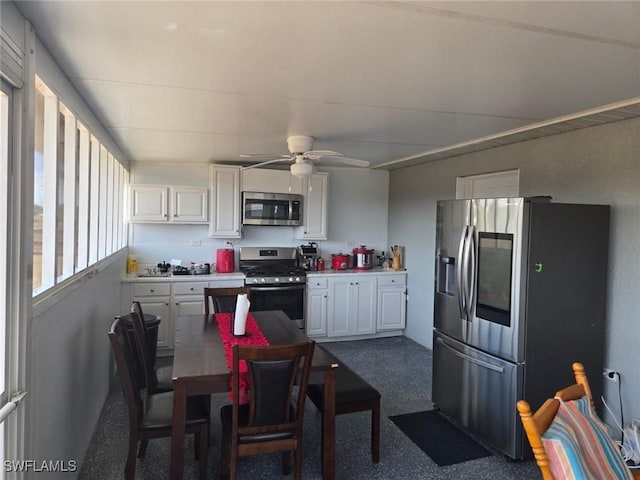 332 Pembroke St, Lehigh Acres, FL 33974 - kitchen featuring stainless steel appliances, white cabinets, ceiling fan, and light countertops