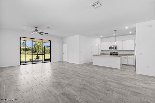 11226 Shady Blossom Dr, Fort Myers, FL 33913 - unfurnished living room featuring recessed lighting, ceiling fan, baseboards, and a sink