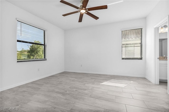 11226 Shady Blossom Dr, Fort Myers, FL 33913 - unfurnished room with plenty of natural light, a ceiling fan, and baseboards