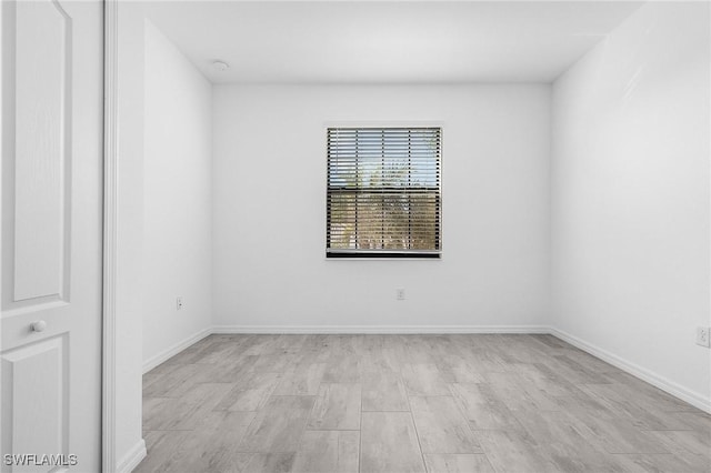 11226 Shady Blossom Dr, Fort Myers, FL 33913 - unfurnished room with light wood-style flooring, baseboards, and a smoke detector