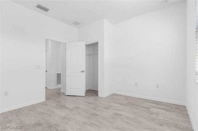 11226 Shady Blossom Dr, Fort Myers, FL 33913 - unfurnished bedroom with a closet, light wood-style flooring, and baseboards