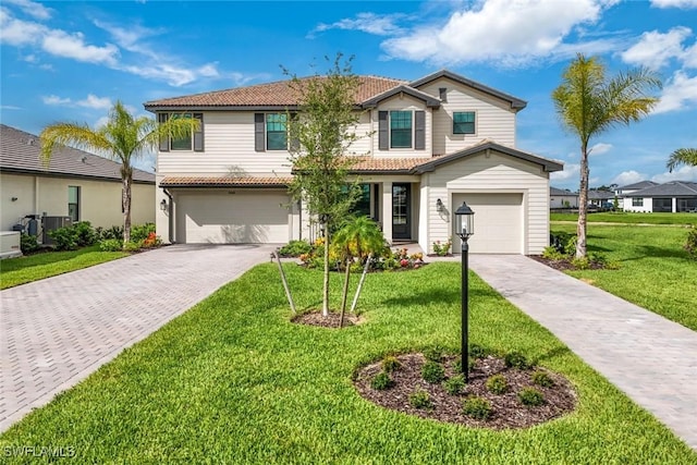 20669 Greenwich Pl, Estero, FL 33928 - traditional-style home with a tile roof, driveway, an attached garage, and a front yard