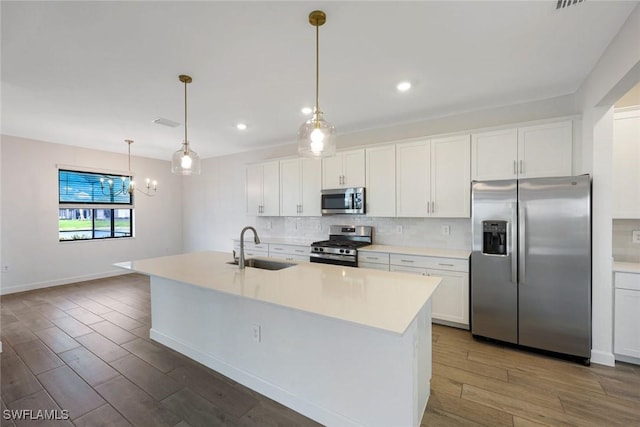 20669 Greenwich Pl, Estero, FL 33928 - kitchen featuring stainless steel appliances, wood finished floors, decorative backsplash, white cabinetry, and recessed lighting