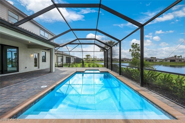 20669 Greenwich Pl, Estero, FL 33928 - view of swimming pool featuring a patio area, a water view, a pool with connected hot tub, and a lanai
