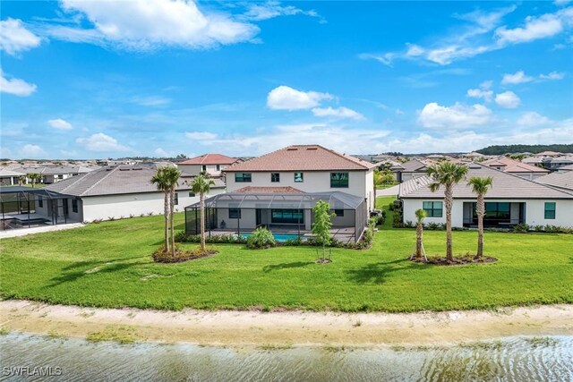20669 Greenwich Pl, Estero, FL 33928 - rear view of property featuring a lanai, a residential view, a lawn, and a water view