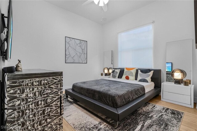 3813 Columbia Ct, Naples, FL 34119 - bedroom with wood finished floors and a ceiling fan