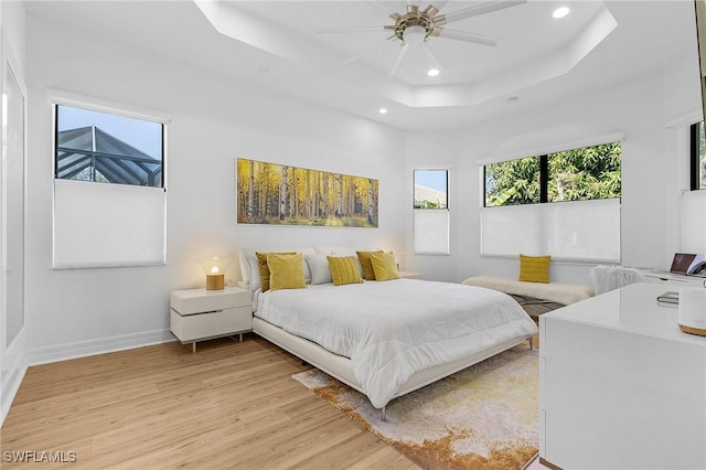 3813 Columbia Ct, Naples, FL 34119 - bedroom featuring light wood-style flooring, recessed lighting, a raised ceiling, baseboards, and ceiling fan