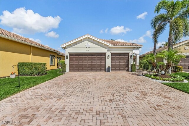 3813 Columbia Ct, Naples, FL 34119 - mediterranean / spanish-style house with decorative driveway, a garage, and stucco siding