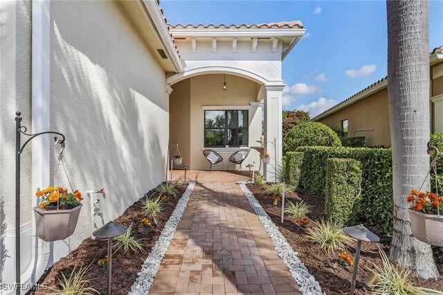 3813 Columbia Ct, Naples, FL 34119 - property entrance with stucco siding