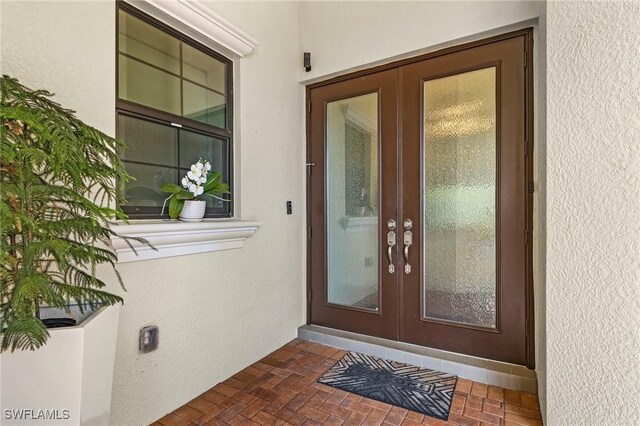 3813 Columbia Ct, Naples, FL 34119 - view of exterior entry with french doors and stucco siding