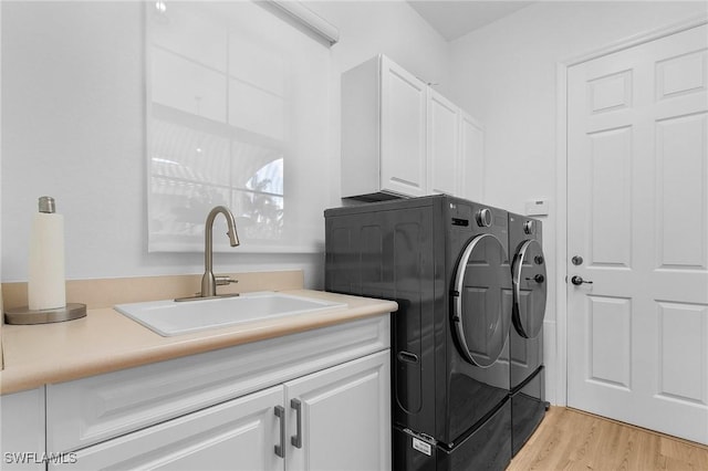 3813 Columbia Ct, Naples, FL 34119 - laundry room featuring washing machine and clothes dryer, cabinet space, and light wood finished floors