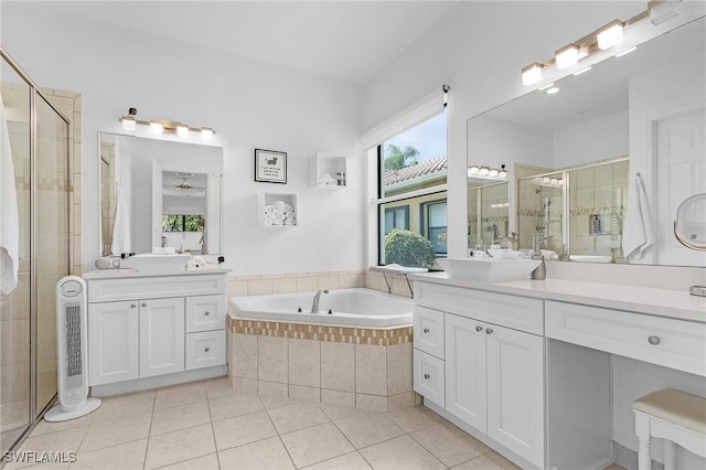 3813 Columbia Ct, Naples, FL 34119 - bathroom with tile patterned flooring, a shower stall, two vanities, and a bath