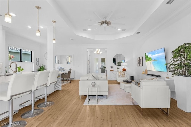 3813 Columbia Ct, Naples, FL 34119 - living room featuring light wood-style floors, a raised ceiling, a chandelier, and recessed lighting
