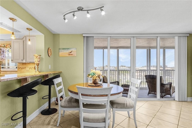 7150 Estero Blvd Unit 706, Fort Myers Beach, FL 33931 - dining space with light tile patterned flooring, healthy amount of natural light, and baseboards