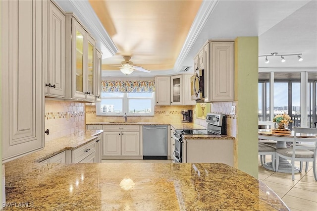 7150 Estero Blvd Unit 706, Fort Myers Beach, FL 33931 - kitchen with stainless steel appliances, a sink, light stone countertops, a tray ceiling, and ceiling fan