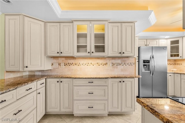 7150 Estero Blvd Unit 706, Fort Myers Beach, FL 33931 - kitchen with stainless steel refrigerator with ice dispenser, a tray ceiling, backsplash, light stone countertops, and light tile patterned floors