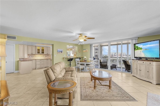 7150 Estero Blvd Unit 706, Fort Myers Beach, FL 33931 - living room featuring a ceiling fan, light tile patterned floors, and a textured ceiling