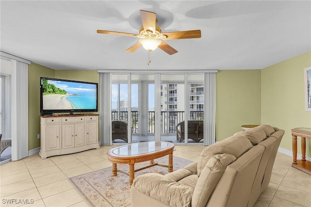 7150 Estero Blvd Unit 706, Fort Myers Beach, FL 33931 - living area featuring light tile patterned floors, a ceiling fan, and baseboards