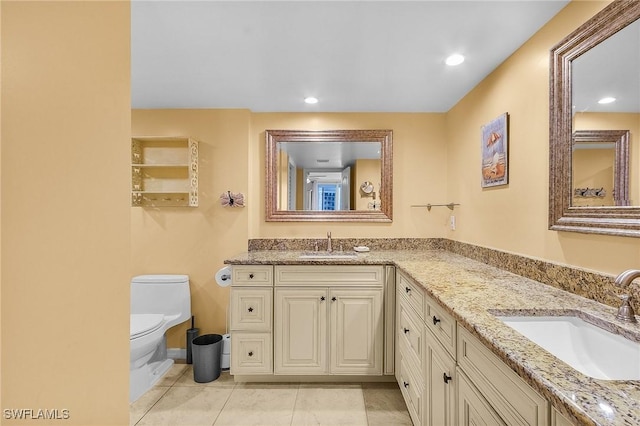 7150 Estero Blvd Unit 706, Fort Myers Beach, FL 33931 - full bathroom with double vanity, toilet, tile patterned floors, baseboards, and recessed lighting