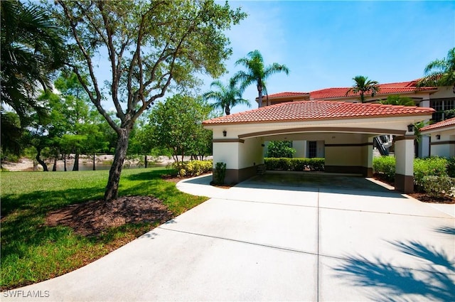 11111 Corsia Trieste Way Unit 101, Bonita Springs, FL 34135 - mediterranean / spanish-style house with concrete driveway, stucco siding, a tiled roof, a front yard, and a carport