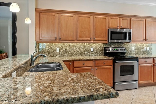 11111 Corsia Trieste Way Unit 101, Bonita Springs, FL 34135 - kitchen featuring stainless steel appliances, a sink, light stone counters, and backsplash