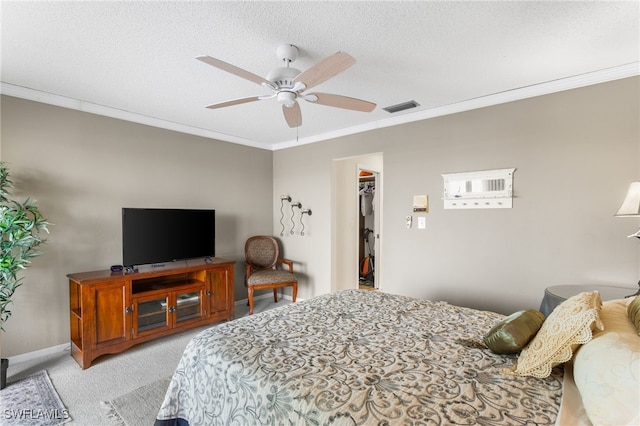 4210 SE 20th Pl Unit A8, Cape Coral, FL 33904 - bedroom with light colored carpet, crown molding, a spacious closet, a ceiling fan, and a textured ceiling