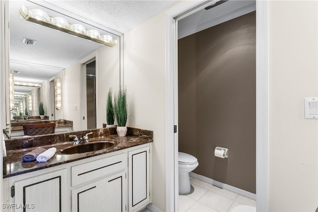 4210 SE 20th Pl Unit A8, Cape Coral, FL 33904 - bathroom featuring toilet, vanity, a textured ceiling, tile patterned floors, and baseboards