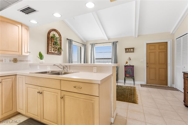 4210 SE 20th Pl Unit A8, Cape Coral, FL 33904 - kitchen with a sink, light brown cabinetry, a peninsula, light countertops, and light tile patterned flooring