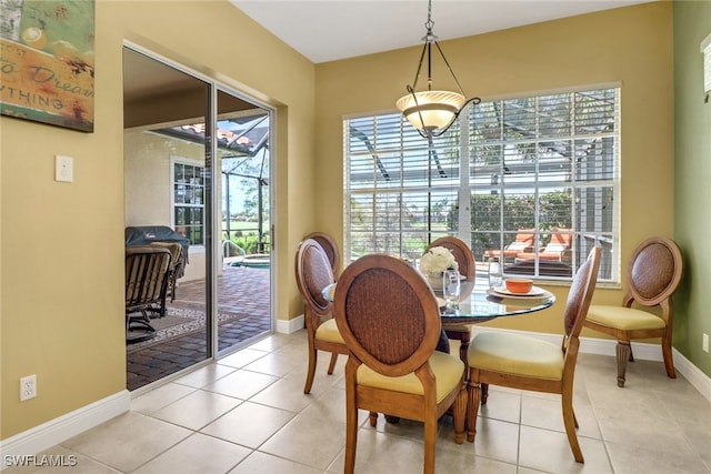 14586 Speranza Way, Bonita Springs, FL 34135 - dining area with a sunroom, baseboards, and light tile patterned flooring