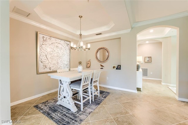 10517 Casella Way Unit 101, Fort Myers, FL 33913 - dining space featuring a tray ceiling, arched walkways, tile patterned floors, crown molding, and a chandelier