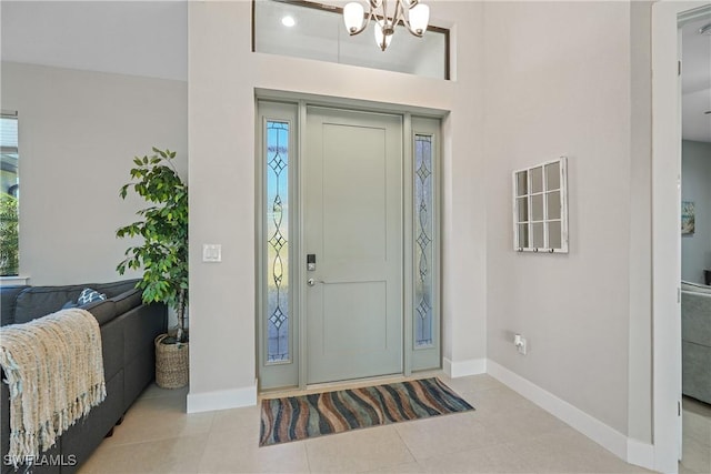 2519 SW 15th Ave, Cape Coral, FL 33914 - tiled entrance foyer with baseboards, plenty of natural light, and a chandelier
