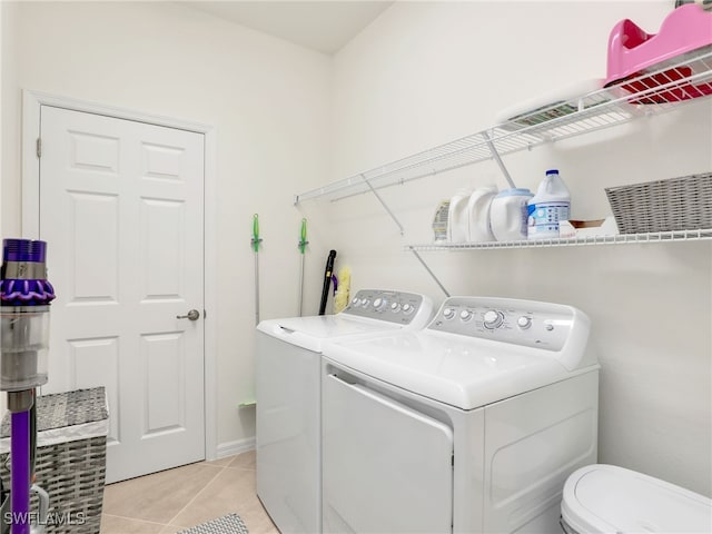 11796 Grand Belvedere Way Unit 202, Fort Myers, FL 33913 - washroom with washing machine and clothes dryer and light tile patterned floors