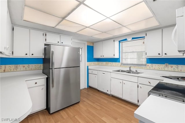 2330 Caladium Rd, Fort Myers, FL 33905 - kitchen with freestanding refrigerator, dishwasher, light wood-style floors, and light countertops