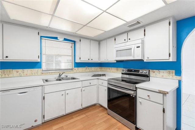 2330 Caladium Rd, Fort Myers, FL 33905 - kitchen featuring white appliances, light countertops, light wood-type flooring, white cabinetry, and a paneled ceiling