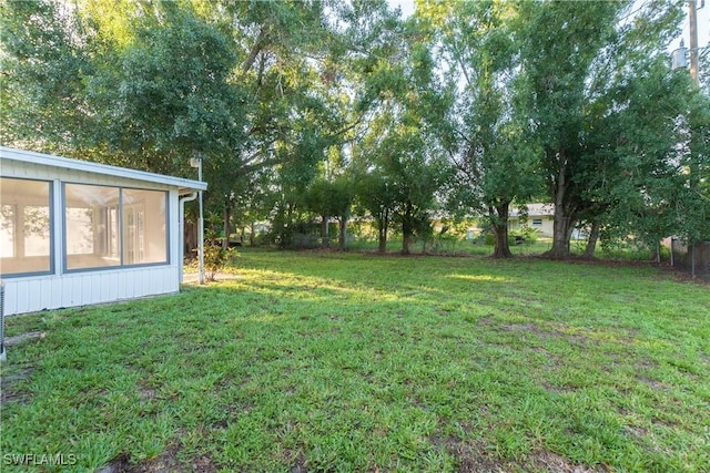 2330 Caladium Rd, Fort Myers, FL 33905 - view of green lawn featuring a sunroom