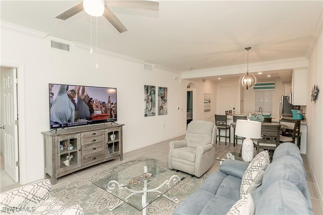 43000 Greenway Blvd Unit 114, Punta Gorda, FL 33982 - living area with arched walkways, light tile patterned floors, ceiling fan, ornamental molding, and baseboards