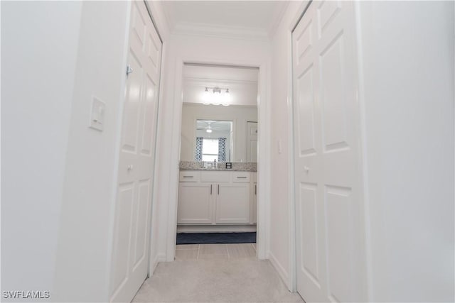 43000 Greenway Blvd Unit 114, Punta Gorda, FL 33982 - hallway featuring light colored carpet, crown molding, and a sink